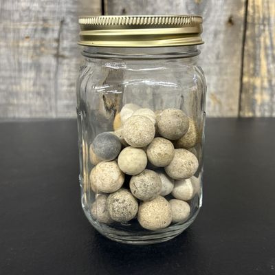 Sale Photo Thumbnail #660: A Collection of Antique Clay Marbles in a Glass Canning Jar
