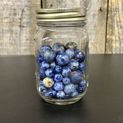 Sale Photo Thumbnail #429: A Collection of Sodalite and Jasper Stone Marbles in a Glass Mason Jar