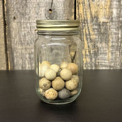 Sale Photo Thumbnail #304: A Collection of Antique Clay Marbles in a Graduated Glass Jar