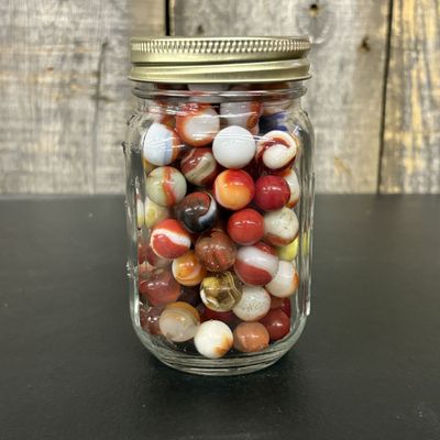 Sale Photo Thumbnail #556: An Assortment of Vintage Machine-Made Glass Marbles in a Graduated Glass Jar