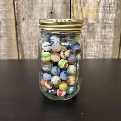 Sale Photo Thumbnail #302: A Collection of Assorted Vintage and Contemporary Glass Marbles in a Graduated Glass Jar
