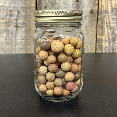 Sale Photo Thumbnail #434: A Collection of Antique Earthenware Game Marbles in a Modern Glass Jar