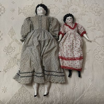 Sale Photo Thumbnail #492: A Pair of China Head Dolls with Cloth Bodies and Molded Hair