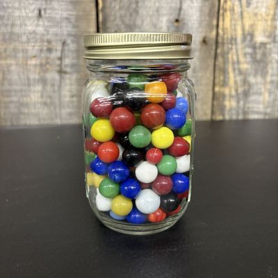 Sale Photo Thumbnail #440: An Assortment of Glass Marbles in a Graduated Glass Storage Jar