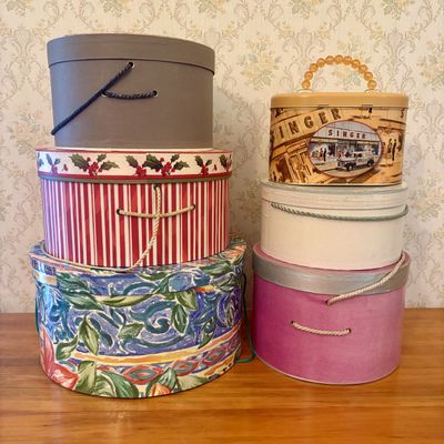 Sale Photo Thumbnail #520: An Assortment of Decorative Cardboard Hat Boxes and a Singer Commemorative Metal Tin