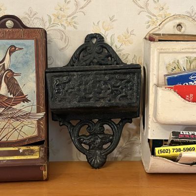 Sale Photo Thumbnail #539: Trio of Vintage Wall Mounted Match Holders Including Lithographed Tin and Cast Iron
