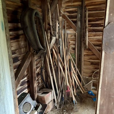 Sale Photo Thumbnail #793: An Assortment of Vintage Agricultural, Woodworking, and Utility Tools Including Horse Collar, Crosscut Saw, and Traps