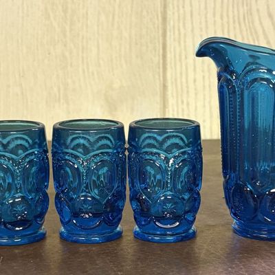 Sale Photo Thumbnail #701: A Set of Moon and Star Pattern Turquoise Pressed Glass Creamer and Footed Tumblers