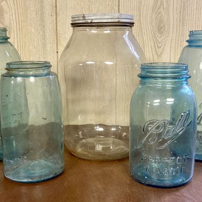 Sale Photo Thumbnail #690: An Assortment of Vintage Blue Glass Ball and Atlas Mason Jars and a Large Clear Glass Jar