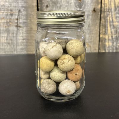 Sale Photo Thumbnail #427: A Collection of Antique Hand-Formed Earthenware Marbles in a Glass Mason Jar