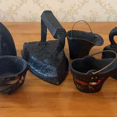 Sale Photo Thumbnail #465: A Collection of Seven Cast Iron Sad Irons and Miniature Painted Coal Scuttles