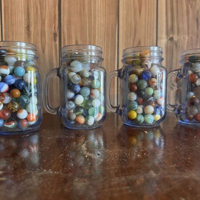 Sale Photo Thumbnail #212: A Collection of Approximately 200-250 Assorted Glass and Clay Marbles in Four Glass Mugs
