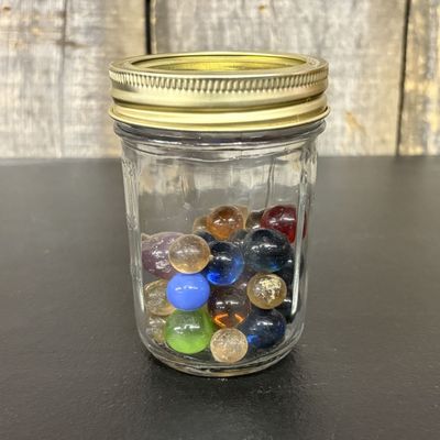Sale Photo Thumbnail #765: A Collection of Glass Marbles in a Glass Canning Jar