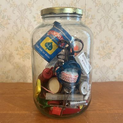 Sale Photo Thumbnail #264: Collection of Vintage Advertising Tins, Antique Doll Limbs, and Miscellaneous Curiosities in Large Glass Jar