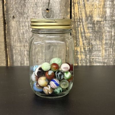 Sale Photo Thumbnail #308: A Collection of Vintage Glass Marbles in a Graduated Glass Jar