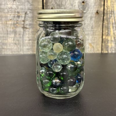 Sale Photo Thumbnail #436: A Collection of Assorted Glass Marbles in a Clear Glass Utility Jar