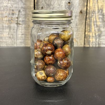 Sale Photo Thumbnail #438: A Collection of Antique Glazed and Common Clay Marbles in a Graduated Glass Jar