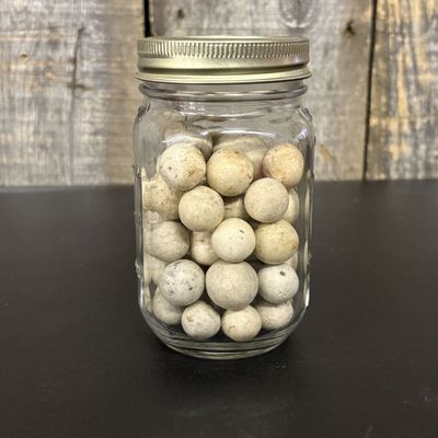 Sale Photo Thumbnail #428: A Collection of Vintage Clay Marbles in a Glass Measuring Jar
