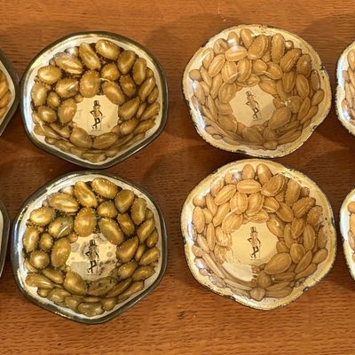A Set of Eight Vintage Planters Mr. Peanut Lithographed Tin Nut Dishes