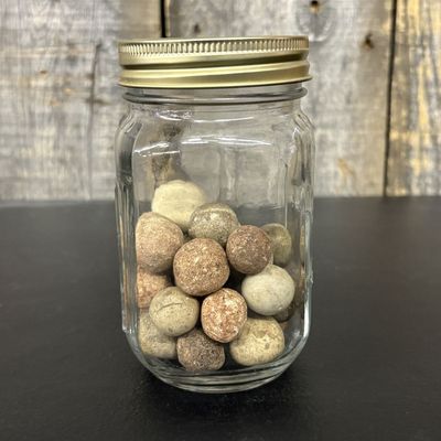Sale Photo Thumbnail #659: A Collection of Antique Clay Marbles in a Graduated Glass Jar