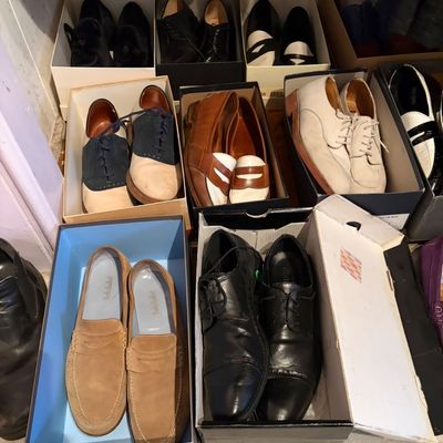 Collection of men's vintage dress shoes and loafers in original boxes, including saddle shoes, penny loafers, and oxfords.