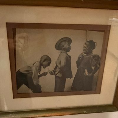Framed vintage black-and-white print depicting three children, housed in a double mat and wooden frame.