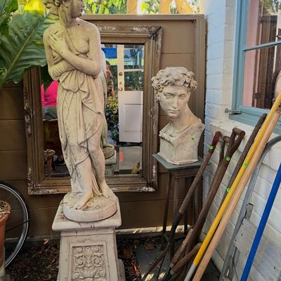 Classical-style cast stone full-length female garden statue on a decorative pedestal alongside a classical bust head statue and various...
