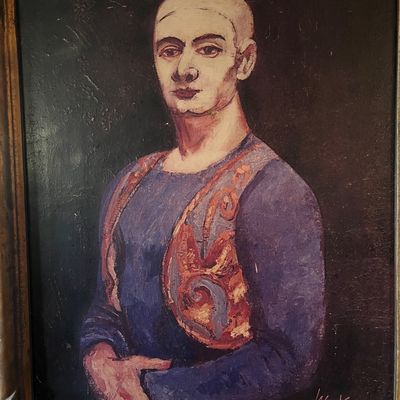 Framed modernist oil portrait of a bald figure in a blue shirt and patterned vest, signed Walt Kuhn and dated 1931 lower right.