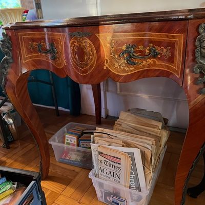 French Louis XV-style marquetry console table featuring intricate wood inlay, ornate brass hardware, and cabriole legs.