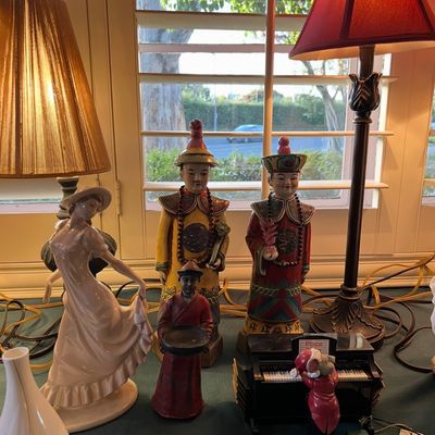 Assortment of decorative figurines including vintage Chinese emperor and empress statues, a porcelain lady figurine, a miniature piano...