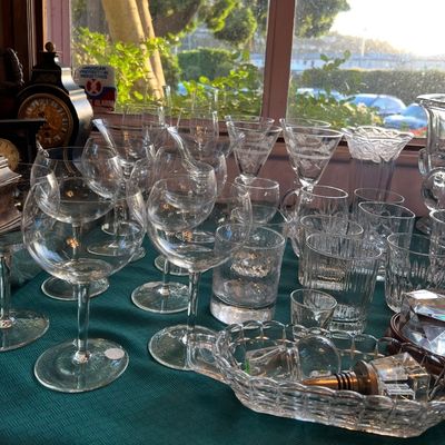 Large collection of vintage crystal and glassware, including stemmed wine goblets, etched martini glasses, cut-glass tumblers, and a...