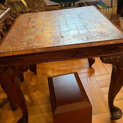 Vintage inlaid wooden games table featuring a mother-of-pearl chessboard top, floral scroll accent borders, and cabriole legs.
