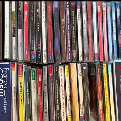 Collection of classical music and opera CDs, including titles by Franco Corelli, Leontyne Price, Josh Groban, and Andrea Bocelli.