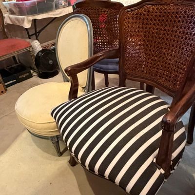 French Provincial style armchair with a woven cane back and black-and-white striped upholstered seat, shown alongside additional accent...