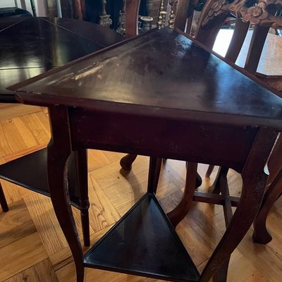Vintage dark stain wooden triangular accent table featuring cabriole legs and a lower tier shelf.