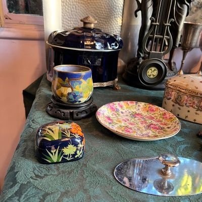 Collection of decorative collectibles, including a floral cloisonné cup on a carved wooden base, a cobalt glass lidded dish, and a small...