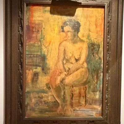 Mid-century expressionist oil portrait of a seated female nude, housed in a carved dark wood frame with an attached picture light.