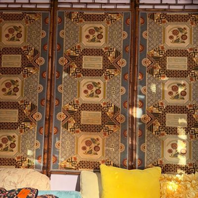 Large three-panel faux-bamboo screen wall hanging with patterned fabric featuring floral motifs.