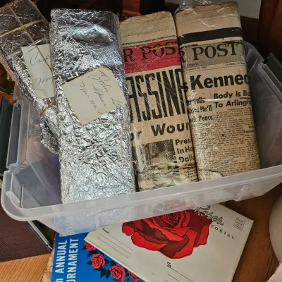 Vintage newspapers covering the John F. Kennedy assassination, including issues of The Denver Post from November 1963, stored alongside...