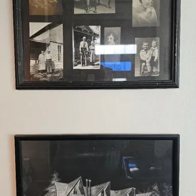 Two framed wall hangings, including a multi-photo collage of vintage family portraits and an architectural rendering of a Breckenridge...