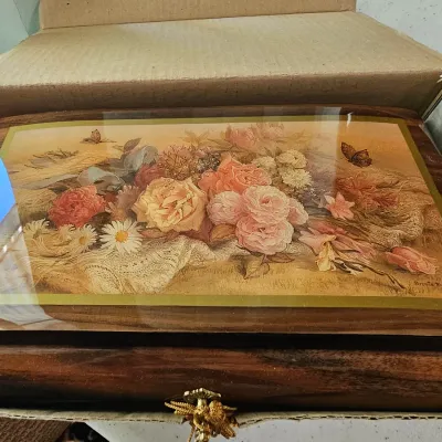 Vintage wooden music box featuring a high-gloss floral print lid by artist Brenda Burke, housed in its original cardboard box.