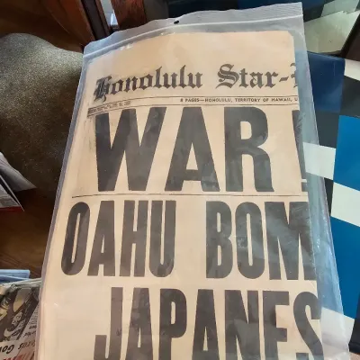 Vintage Honolulu Star-Bulletin newspaper from December 7, 1941, featuring the historic "WAR! OAHU BOMB BY JAPANESE" headline,...