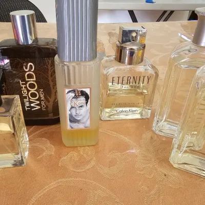 Collection of men's fragrances including Ralph Lauren Romance, Bath & Body Works Twilight Woods, Calvin Klein Eternity, and...