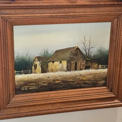 Framed oil painting of a rustic barn landscape, signed by artist Herb Welsh, housed in a thick, molded wooden frame.