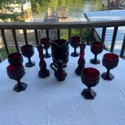 Sale Photo Thumbnail #67: Vintage Indiana Glass ruby red Whitehall pattern glassware set, including goblets, candlesticks, a pitcher, and a small cruet.