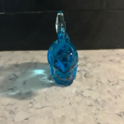 Sale Photo Thumbnail #56: Small, vintage blue glass rabbit figurine, likely a paperweight or decorative collectible, shown from the front.