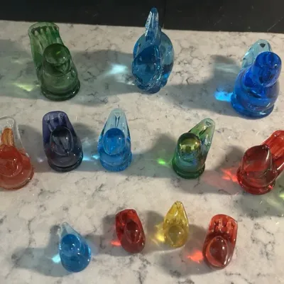 Sale Photo Thumbnail #51: Collection of vintage glass bird figurines in various sizes and colors, including shades of blue, green, red, and yellow.