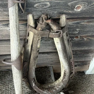 Sale Photo Thumbnail #24: Antique horse collar and hames with weathered wood and rusted iron hardware, showing significant age and wear.
