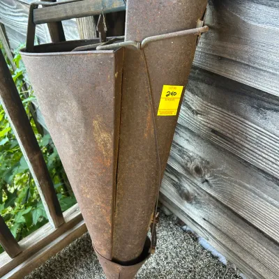 Sale Photo Thumbnail #111: Vintage metal hand planter with a rusted finish and wooden handle, showing significant wear and patina.