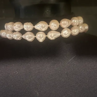 Sale Photo Thumbnail #78: Two-strand choker necklace featuring baroque pearls with a soft pinkish-white luster, displayed on a black jewelry bust.